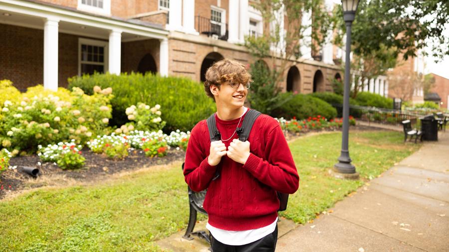 Student with backpack walking on campus